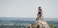 Handsome guy with bike on top of the mountain Royalty Free Stock Photo