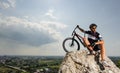 Handsome guy with bike on top of the mountain Royalty Free Stock Photo