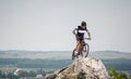 Handsome guy with bike on top of the mountain Royalty Free Stock Photo