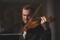 Handsome guy with classic instrument violin