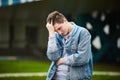 A handsome guy clutched his head, trying to remember something, massaging his head. Royalty Free Stock Photo