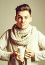 Handsome guy with cup in scarf
