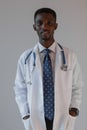 Handsome guy doctor in white lab coat with stethoscope on white background Royalty Free Stock Photo