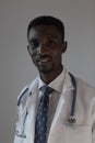 Handsome guy doctor in white lab coat with stethoscope on white background Royalty Free Stock Photo