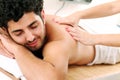 Handsome guy enjoying massage therapy