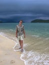 Handsome guy on an exotic beach. walk on the beach before tropical rain