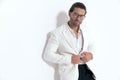handsome guy with glasses unbuttoning white jacket suit and smiling Royalty Free Stock Photo