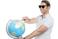 Handsome guy in goggles pointing at globe Royalty Free Stock Photo