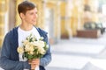 Handsome guy holding flowers Royalty Free Stock Photo