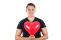 Handsome guy holding a heart-shaped balloon Royalty Free Stock Photo