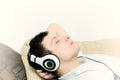 Handsome guy listening to music on headset with eyes closed Royalty Free Stock Photo