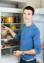 Handsome guy near opened refrigerator Royalty Free Stock Photo