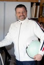 handsome guy portrait of happy middle aged caucasian man car race white jacket and retro racing helmet Royalty Free Stock Photo