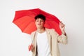 handsome guy red umbrella a man in a light jacket  background unaltered Royalty Free Stock Photo