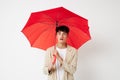handsome guy red umbrella a man in a light jacket  background unaltered Royalty Free Stock Photo