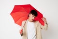 handsome guy red umbrella a man in a light jacket isolated background unaltered Royalty Free Stock Photo