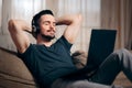 Relaxed Man Listening to Music on His Laptop at Home Royalty Free Stock Photo