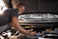 Handsome guy repairing auto`s hood