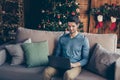 Handsome guy sit couch use computer search christmas season sales to buy fairy magic presents having house with Royalty Free Stock Photo