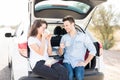 Happy couple on road trip having coffee break Royalty Free Stock Photo