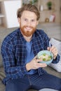 handsome guy smiling while holding bowl with porridge