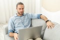 Hipster guy is using the laptop Royalty Free Stock Photo