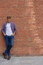 Handsome guy standing near brick wall Royalty Free Stock Photo