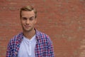 Handsome guy standing near brick wall Royalty Free Stock Photo