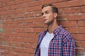 Handsome guy standing near brick wall Royalty Free Stock Photo