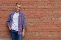 Handsome guy standing near brick wall Royalty Free Stock Photo