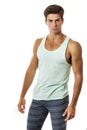 Handsome guy in tank top and leggings on white background . Stylish hair