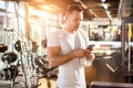 Handsome guy text messaging on his smartphone at gym. Royalty Free Stock Photo
