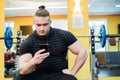 Handsome guy text messaging on his smartphone at gym. Royalty Free Stock Photo