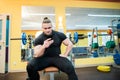Handsome guy text messaging on his smartphone at gym. Royalty Free Stock Photo