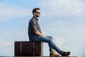 Handsome guy traveler. Guy outdoors with vintage suitcase. Luggage concept. Travel with luggage. Travel blogger Royalty Free Stock Photo
