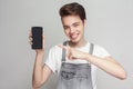 Handsome happy brunette modern young boy in demin overalls stand Royalty Free Stock Photo