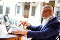 Handsome happy businessman on an online meeting, talking with clients using laptop Royalty Free Stock Photo