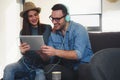 Handsome happy couple listening to music on their mobile devices Royalty Free Stock Photo