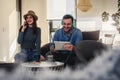 Handsome happy couple listening to music on their mobile devices Royalty Free Stock Photo