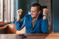 A handsome, happy, funny businessman of European appearance stylish portrait, holds a phone in his hand and listens to music in Royalty Free Stock Photo