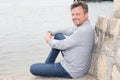 Happy man wearing blue shirt at the sea ocean background in Travel vacation holiday Royalty Free Stock Photo