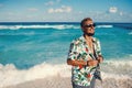 Young happy man wearing hawaiian shirt at the sea or the ocean background Royalty Free Stock Photo