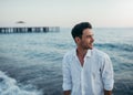 Handsome happy man wearing white shirt at the sea or the ocean b Royalty Free Stock Photo