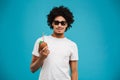 Handsome happy young african curly man drinking cocktail coconut. Royalty Free Stock Photo