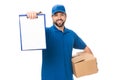 handsome happy young delivery man holding cardboard box and blank clipboard Royalty Free Stock Photo