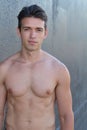 Handsome happy young hispanic man smiling and relaxing near hotel pool. Vertical shape, head, shoulders and torso Royalty Free Stock Photo