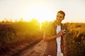 Handsome happy young traveler man with vintage camera,on a meadow background. Travel mood. Photography.