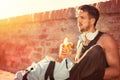 Handsome healthy male runner taking break after fitness workout