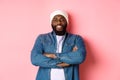 Handsome hip hop style Black man in beanie and denim shirt, smiling confident, cross arms on chest and staring at camera Royalty Free Stock Photo