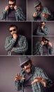 Handsome hipster bearded man with sunglasses and shirt standing against dark gray wall Royalty Free Stock Photo